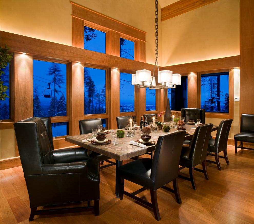 Example of a mid-sized mountain style light wood floor and brown floor enclosed dining room design with beige walls and no fireplace
