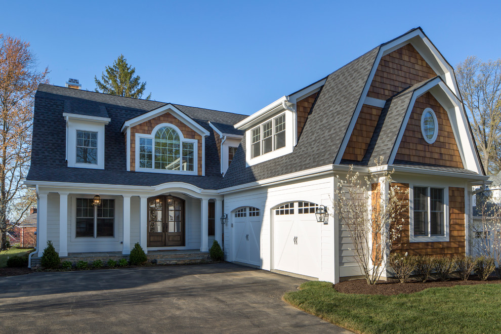 Design ideas for a large traditional two-storey white exterior in Cincinnati with wood siding and a gambrel roof.
