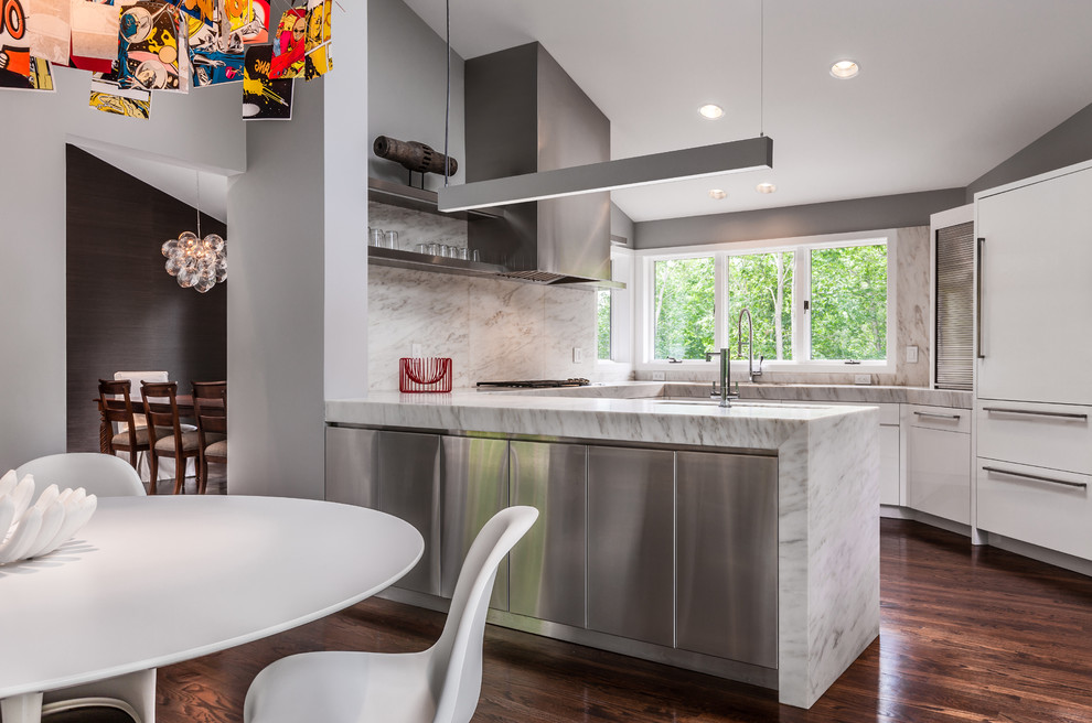 This is an example of a contemporary u-shaped eat-in kitchen in Minneapolis with panelled appliances, flat-panel cabinets, stainless steel cabinets, white splashback and marble splashback.