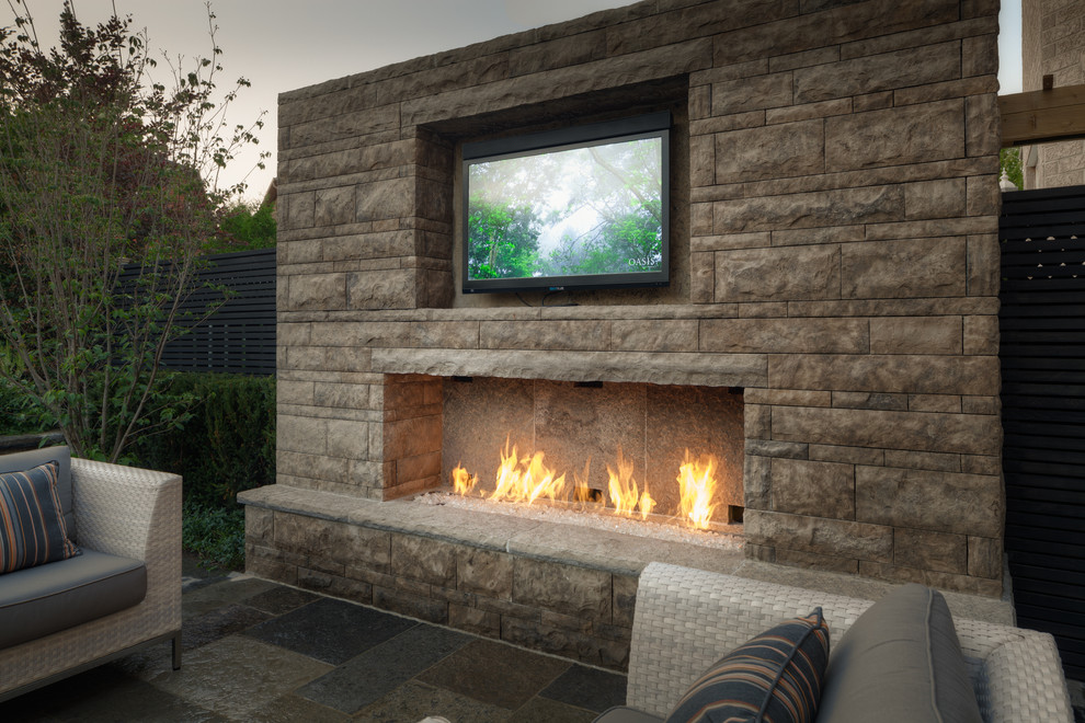 Design ideas for a small transitional patio in Toronto with a fire feature.