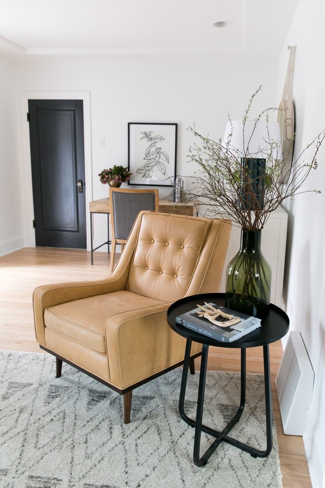 Example of a transitional living room design in Denver