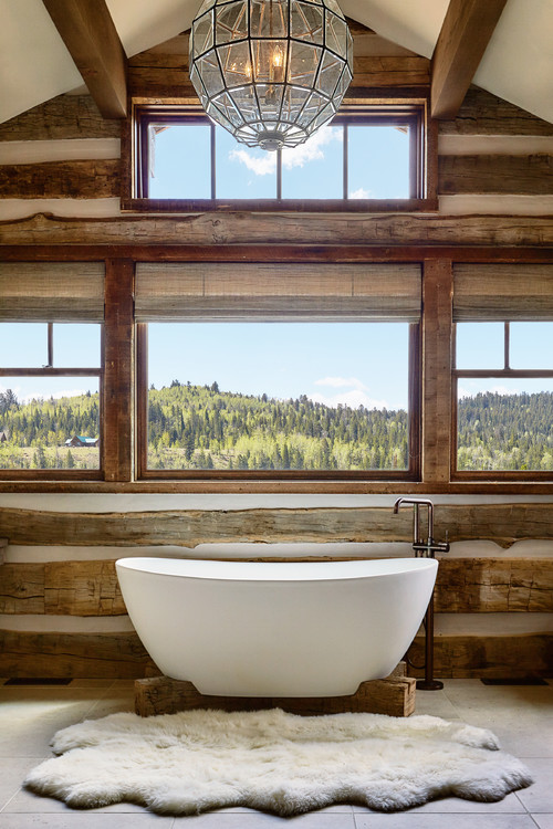 An eclectic-meets-rustic bathroom with a dark and hand-hewn oak wall