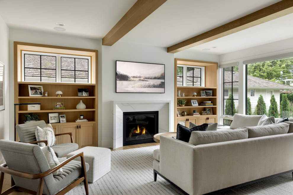 Inspiration for a transitional medium tone wood floor, brown floor and exposed beam living room remodel in Minneapolis with white walls, a standard fireplace and a wall-mounted tv
