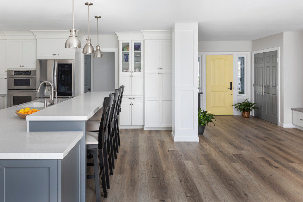 Inspiration for a transitional kitchen in Orange County with quartz benchtops, vinyl floors and with island.