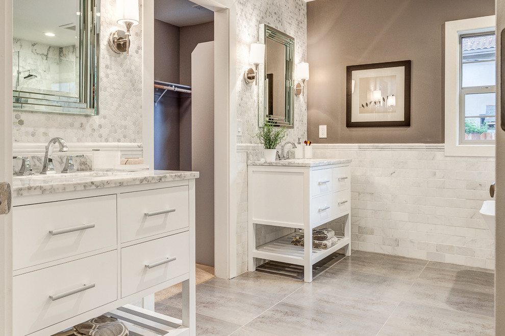 Mid-sized traditional master bathroom in Sacramento with an undermount sink, furniture-like cabinets, white cabinets, marble benchtops, a freestanding tub, a corner shower, a two-piece toilet, white tile, stone tile, brown walls and ceramic floors.