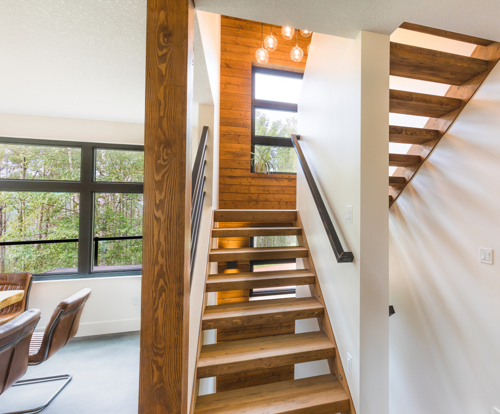 Mid-sized mountain style wooden u-shaped open, metal railing and wood wall staircase photo in Edmonton