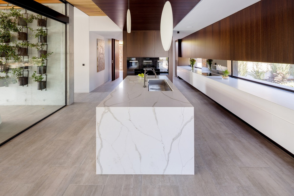 Inspiration for a contemporary galley eat-in kitchen remodel in Canberra - Queanbeyan with quartz countertops, window backsplash, an island and white countertops
