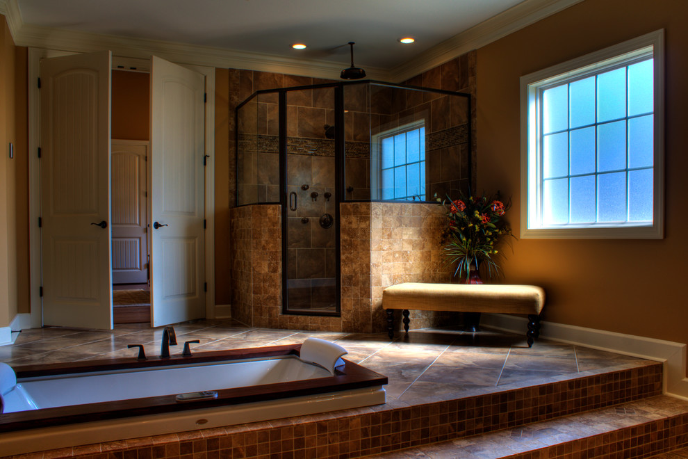 Design ideas for an expansive traditional master bathroom in Other with raised-panel cabinets, dark wood cabinets, granite benchtops, brown tile, porcelain tile, a drop-in tub, a corner shower, a two-piece toilet, an undermount sink, brown walls and porcelain floors.