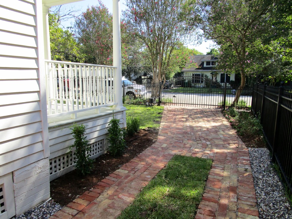 Design ideas for a mid-sized traditional side yard partial sun garden in Houston with brick pavers.