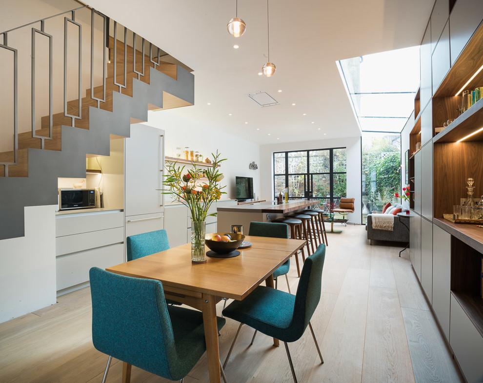Design ideas for a contemporary open plan dining in Kent with grey walls and light hardwood floors.