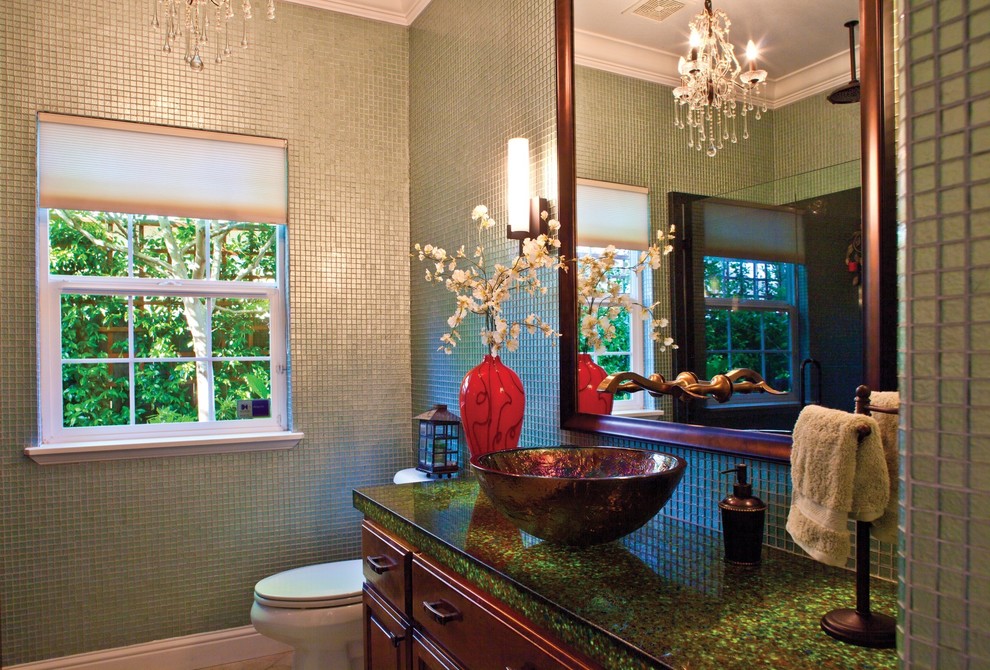 This is an example of a mid-sized eclectic bathroom in Atlanta with brown cabinets, a one-piece toilet and a vessel sink.