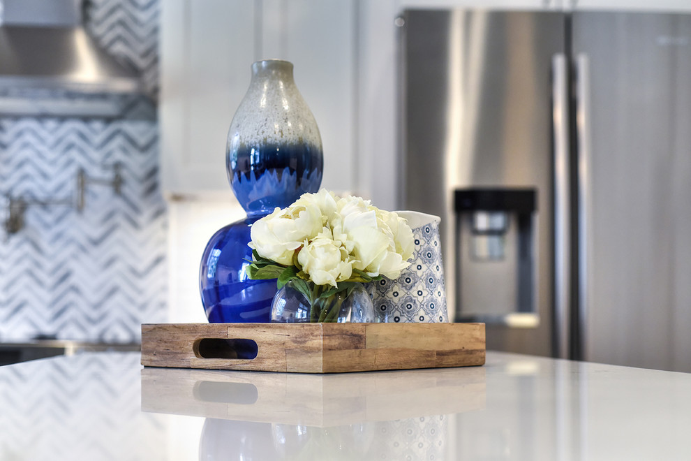 Home design - large transitional l-shaped medium tone wood floor home design idea in Jacksonville with a farmhouse sink, shaker cabinets, quartz countertops and an island