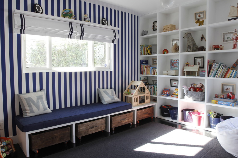 Large transitional gender-neutral kids' playroom in Los Angeles with dark hardwood floors and multi-coloured walls for kids 4-10 years old.