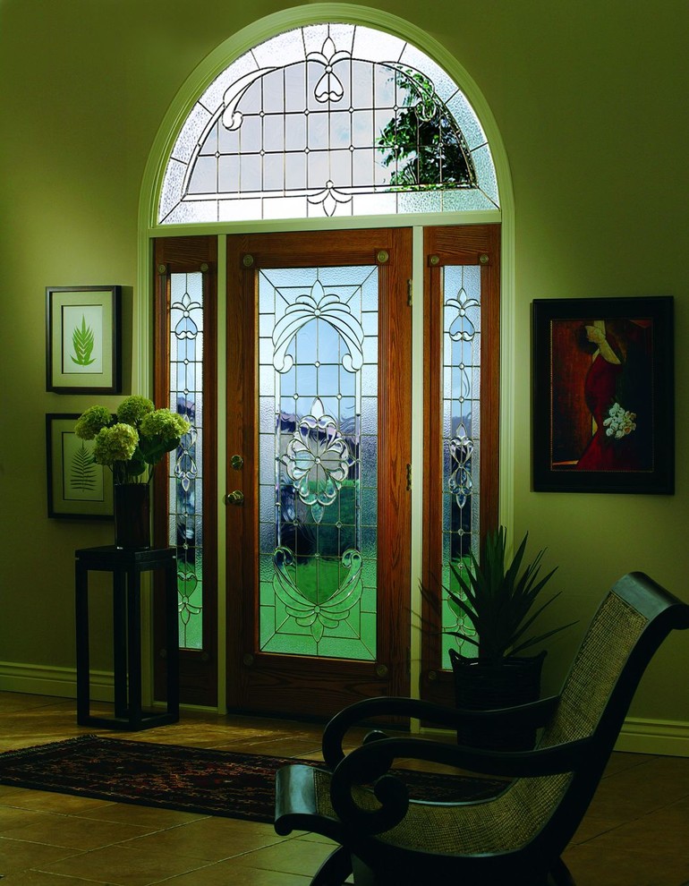 Example of a large transitional front door design in DC Metro with a medium wood front door