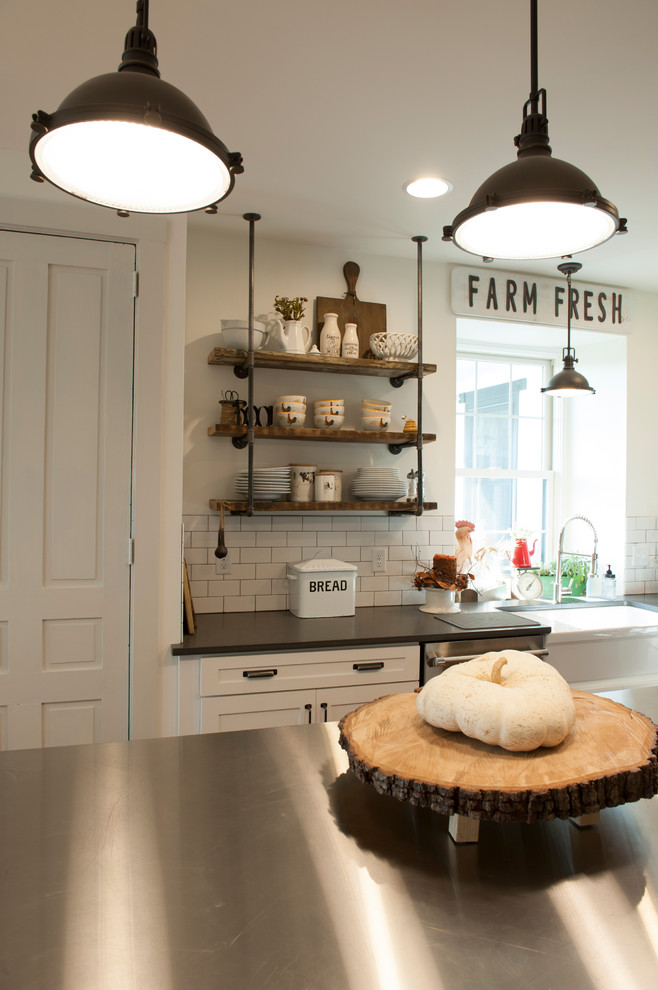 Design ideas for a mid-sized country u-shaped eat-in kitchen in Philadelphia with a farmhouse sink, open cabinets, white splashback, subway tile splashback, stainless steel appliances, medium hardwood floors, with island, brown floor, white cabinets and stainless steel benchtops.