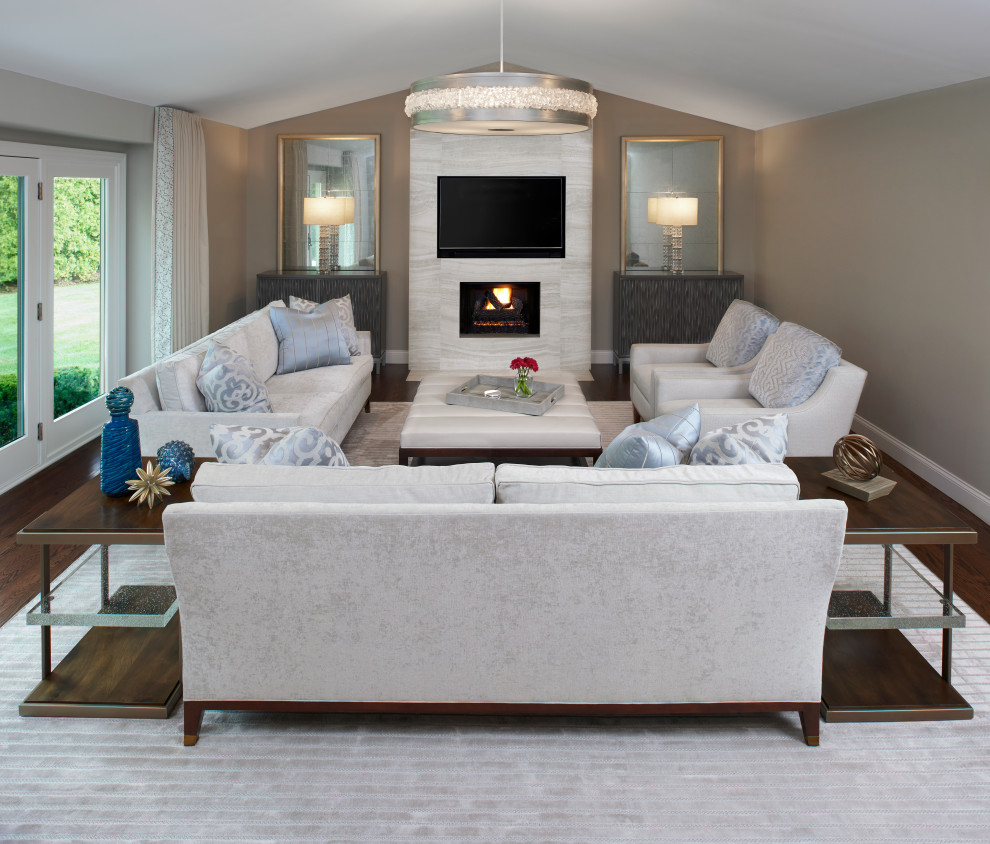 Inspiration for a large transitional open concept family room in Detroit with grey walls, dark hardwood floors, a standard fireplace, a tile fireplace surround, a built-in media wall and brown floor.