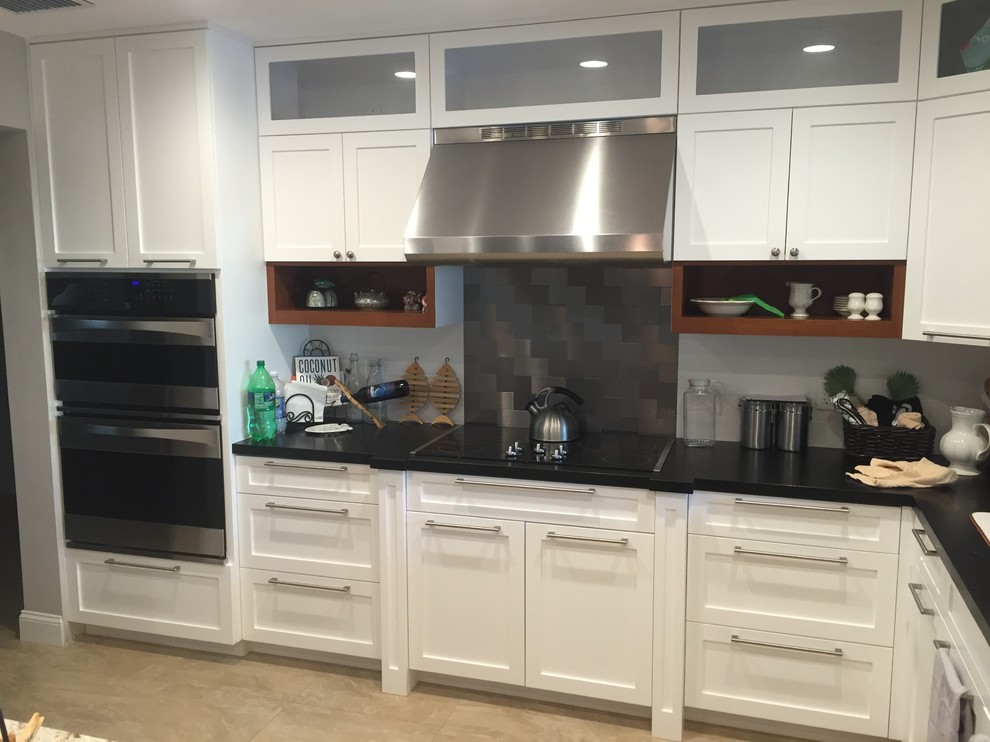 Mid-sized transitional l-shaped eat-in kitchen photo in Miami with shaker cabinets, white cabinets, soapstone countertops and an island