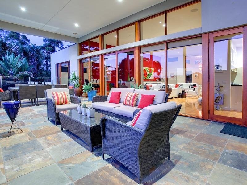 Design ideas for a contemporary backyard patio in Melbourne with a roof extension.
