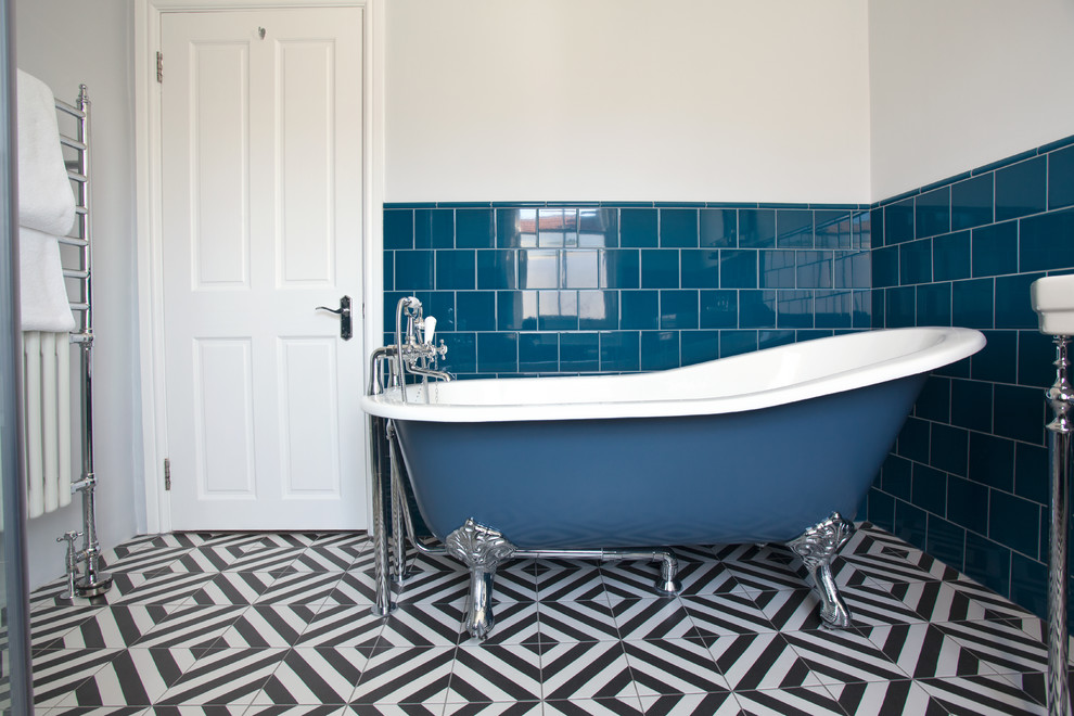 Design ideas for a small industrial bathroom in Sussex with a corner shower, a one-piece toilet, blue tile, ceramic tile, white walls, ceramic floors, a pedestal sink, multi-coloured floor and a hinged shower door.