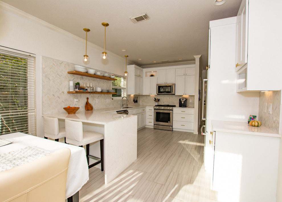Eat-in kitchen - transitional porcelain tile and gray floor eat-in kitchen idea in Austin with an undermount sink, shaker cabinets, white cabinets, quartz countertops, white backsplash, marble backsplash, stainless steel appliances, a peninsula and white countertops