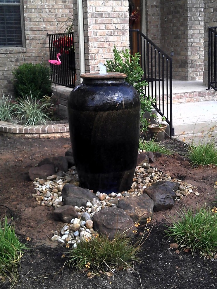 Photo of a small front yard partial sun garden in Austin with a water feature and concrete pavers.