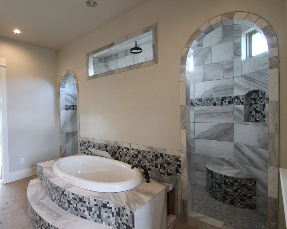 Large mediterranean master bathroom in Austin with a drop-in tub, an open shower, gray tile, white tile, mosaic tile, white walls and limestone floors.
