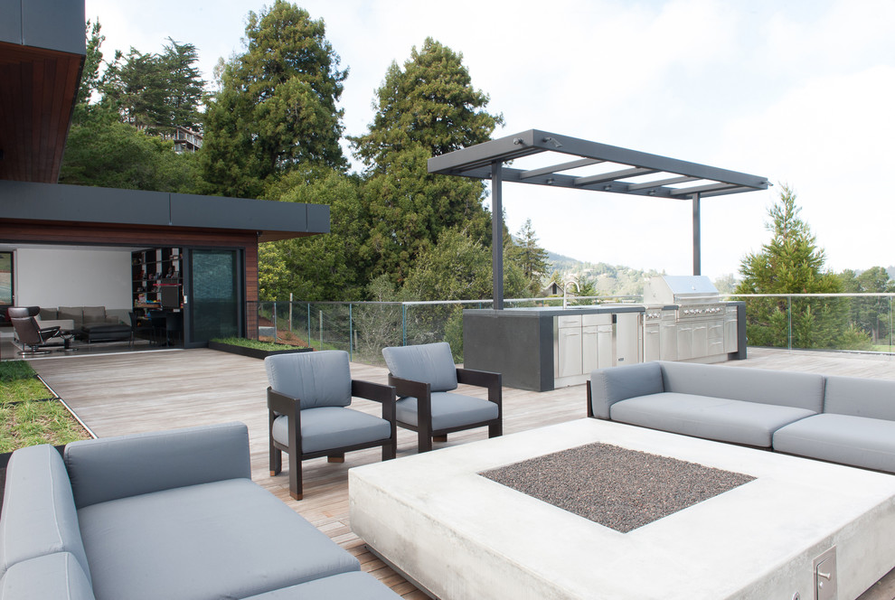 Photo of an expansive contemporary rooftop deck in San Francisco with an outdoor kitchen and a pergola.