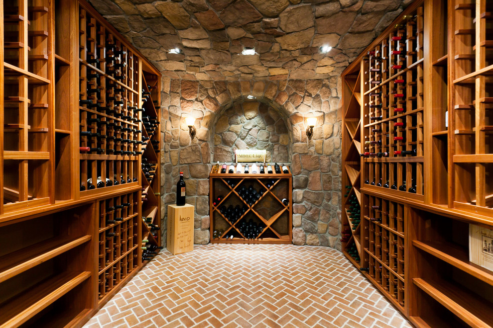 This is an example of a large traditional wine cellar in New York with brick floors, storage racks and red floor.