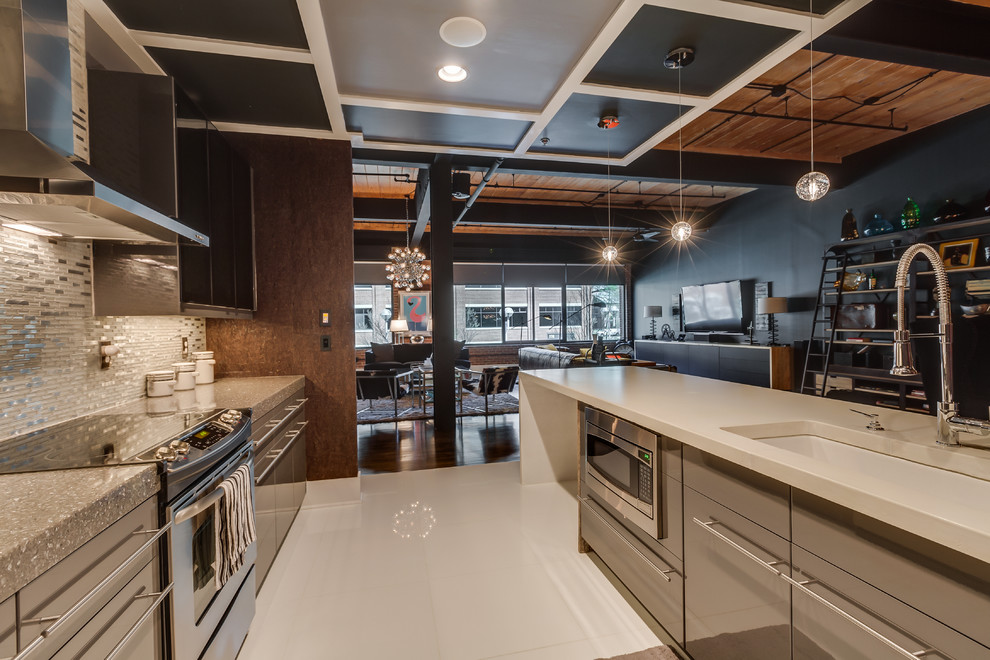 Photo of a large industrial single-wall open plan kitchen in Charlotte with an undermount sink, flat-panel cabinets, grey cabinets, quartz benchtops, metallic splashback, matchstick tile splashback, stainless steel appliances, linoleum floors, with island and white floor.