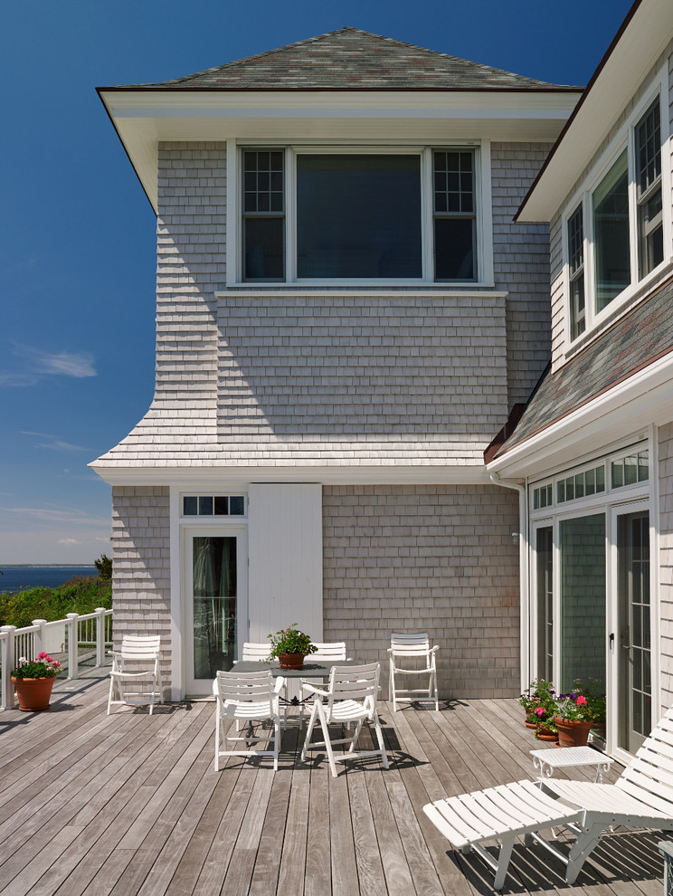 This is an example of a beach style backyard deck in Boston with no cover.