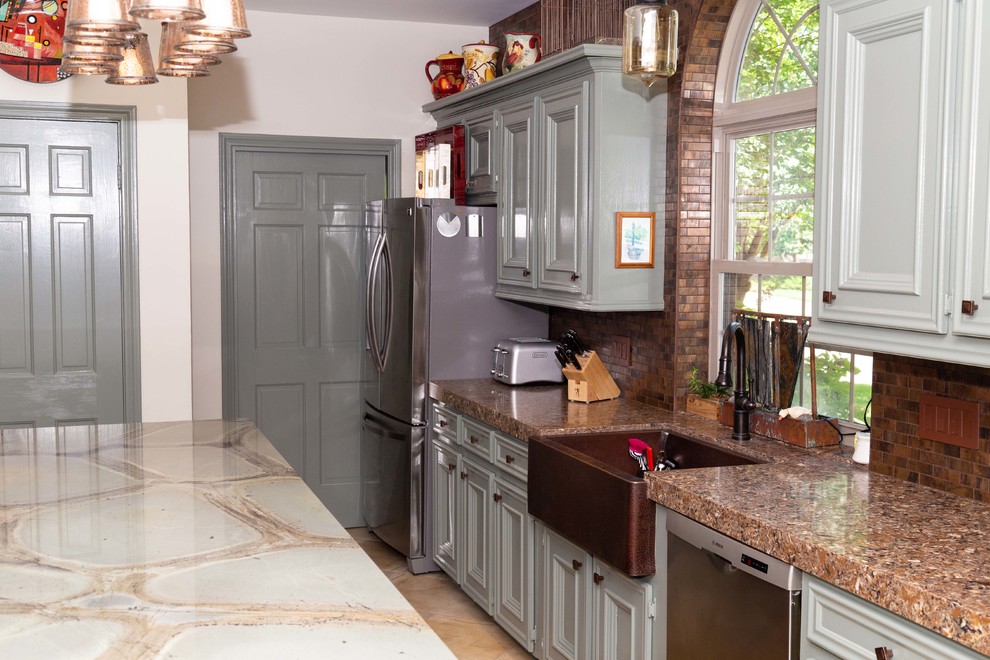 Design ideas for a large country u-shaped kitchen pantry in Houston with a farmhouse sink, beaded inset cabinets, green cabinets, quartzite benchtops, brown splashback, metal splashback, stainless steel appliances, porcelain floors, with island, beige floor and green benchtop.