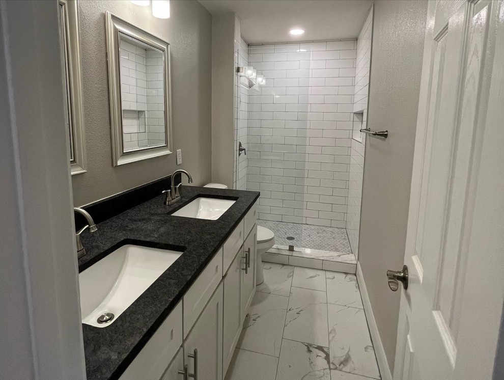 Example of a small transitional master white tile and subway tile porcelain tile, white floor and double-sink alcove shower design in Dallas with shaker cabinets, white cabinets, a two-piece toilet, gray walls, an undermount sink, quartz countertops, black countertops, a niche and a built-in vanity