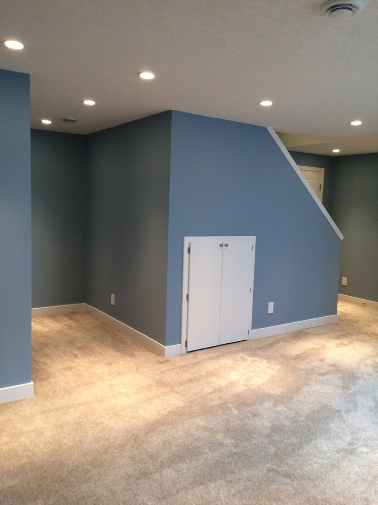 Inspiration for a large transitional look-out carpeted and brown floor basement remodel in Calgary with gray walls and no fireplace
