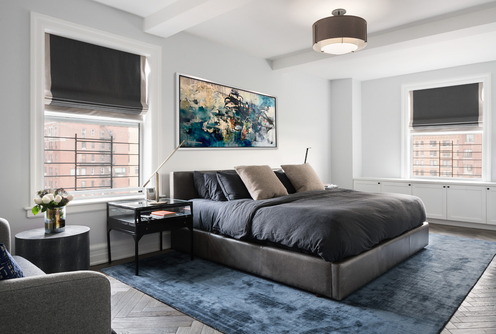 Photo of a contemporary master bedroom in New York with white walls, dark hardwood floors and brown floor.