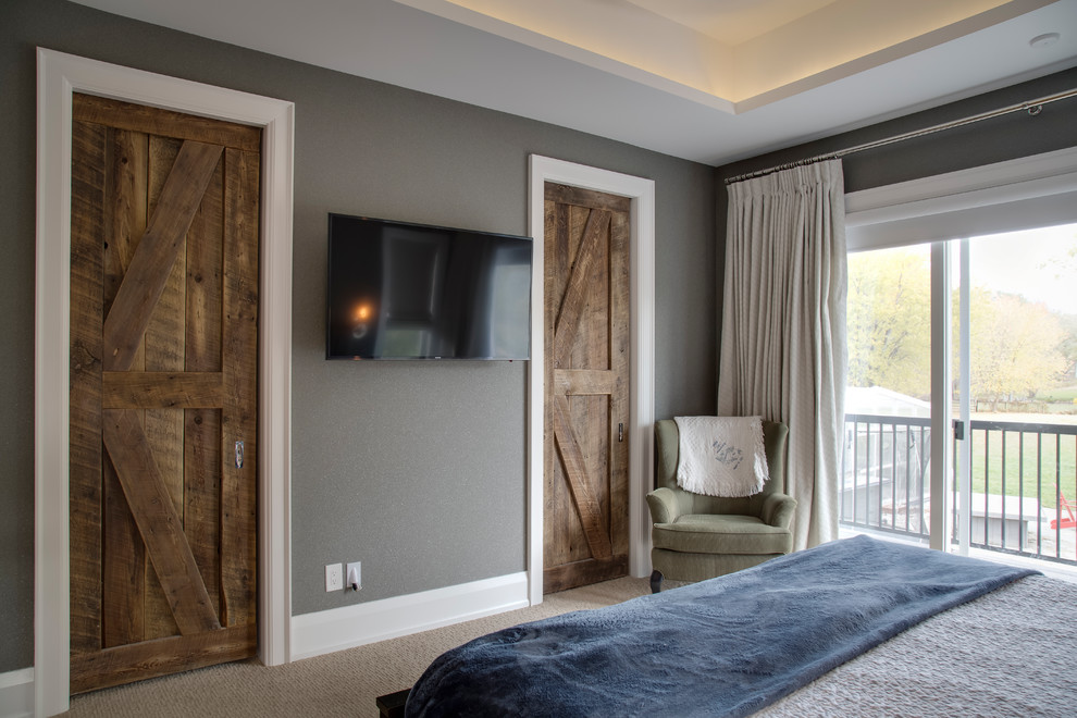 This is an example of a mid-sized country master bedroom with beige walls, carpet, no fireplace and brown floor.