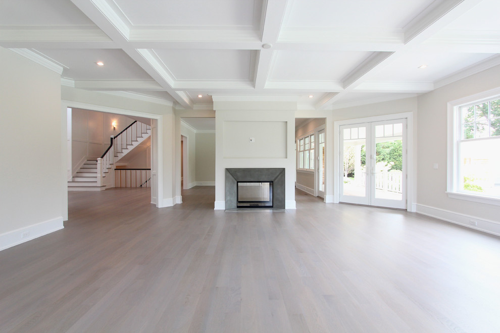 Photo of a large transitional open concept living room in New York with grey walls, light hardwood floors, a two-sided fireplace, a metal fireplace surround, no tv and beige floor.