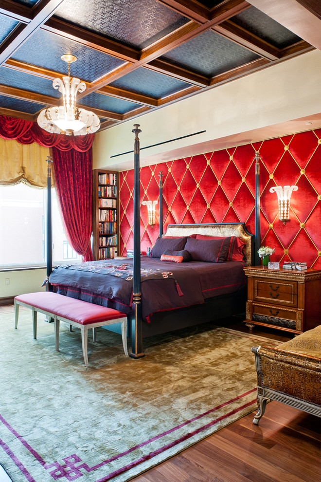 Traditional bedroom in New York with dark hardwood floors and red walls.