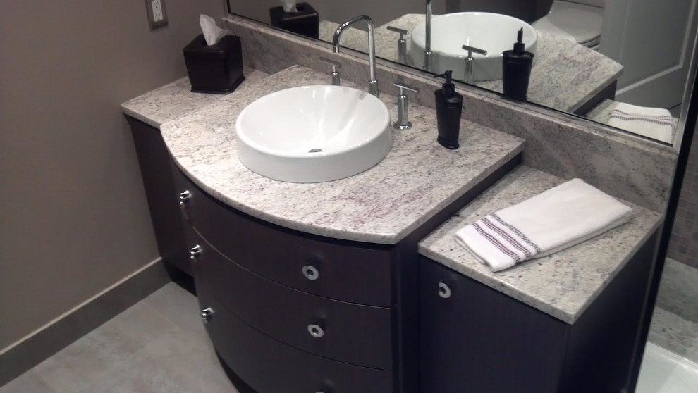 Inspiration for a mid-sized contemporary 3/4 bathroom in Chicago with furniture-like cabinets, dark wood cabinets, grey walls, ceramic floors, a vessel sink, granite benchtops and grey floor.
