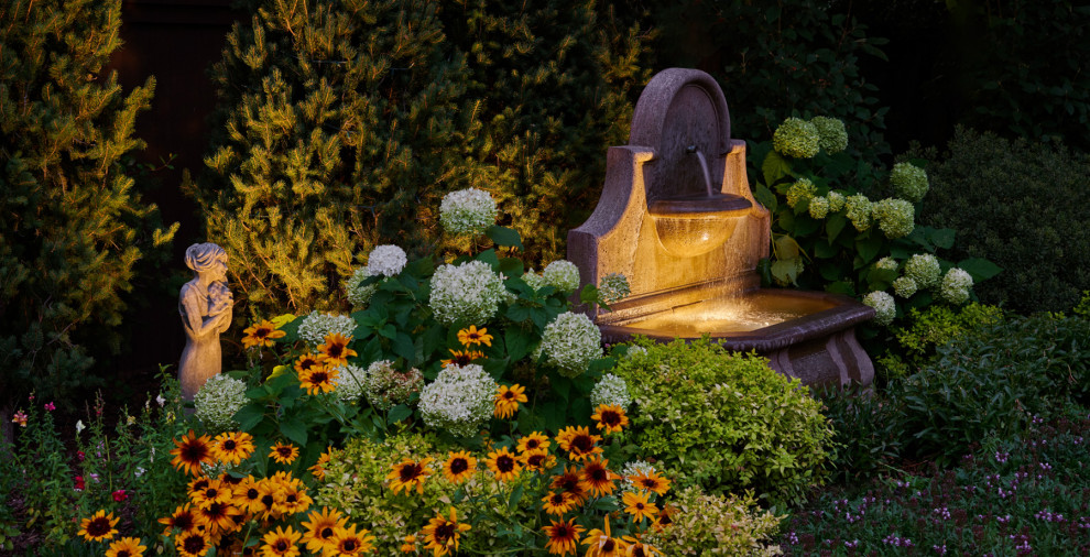 Inspiration for a large craftsman backyard mulch water fountain landscape in Denver for summer.
