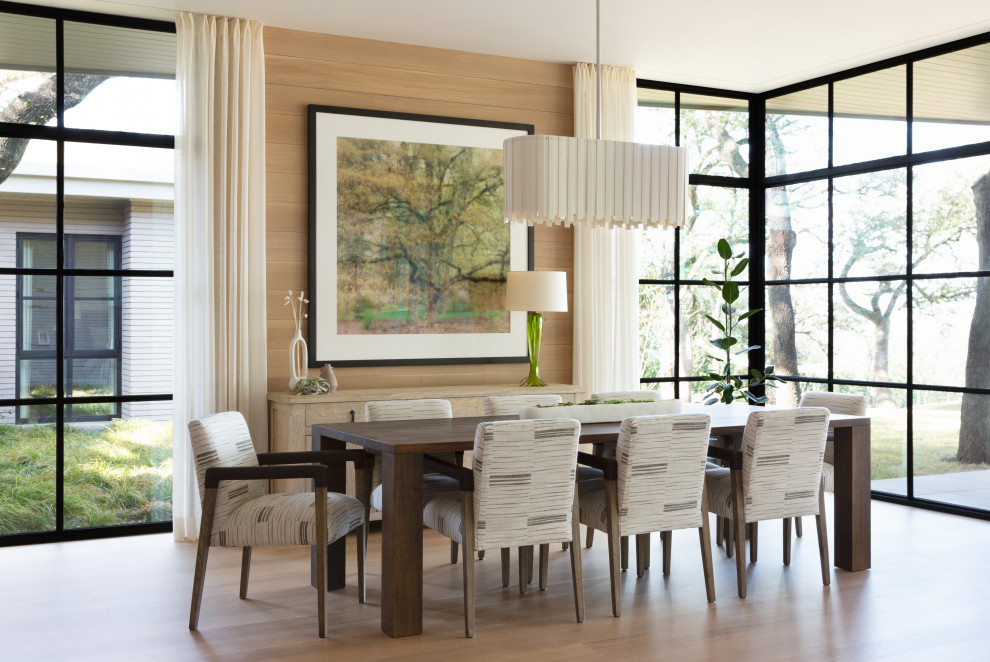 This is an example of a transitional dining room in Austin with beige walls, medium hardwood floors and brown floor.