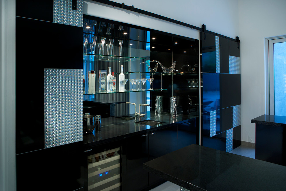 This is an example of a contemporary home bar in Phoenix with black cabinets and mirror splashback.