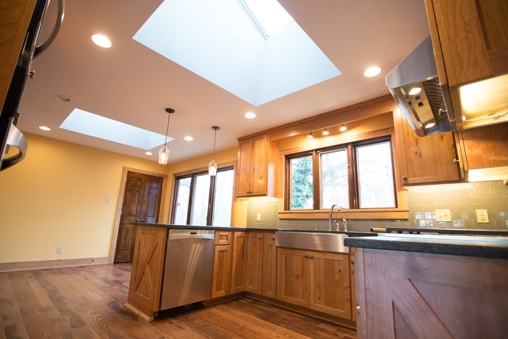 Inspiration for a large rustic u-shaped dark wood floor kitchen pantry remodel with a single-bowl sink, raised-panel cabinets, medium tone wood cabinets, blue backsplash, ceramic backsplash, stainless steel appliances and no island