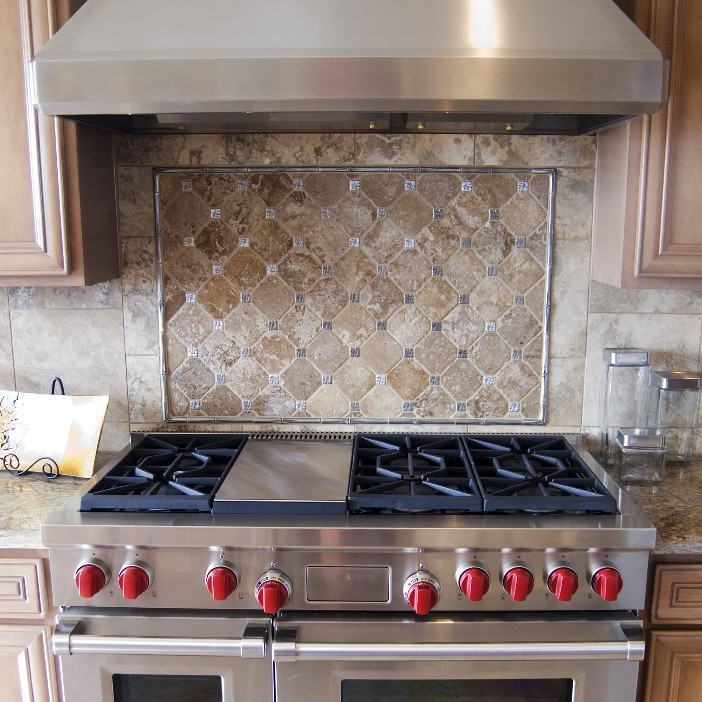Example of a mid-sized transitional kitchen design in Phoenix with recessed-panel cabinets, medium tone wood cabinets, granite countertops, beige backsplash, ceramic backsplash and stainless steel appliances