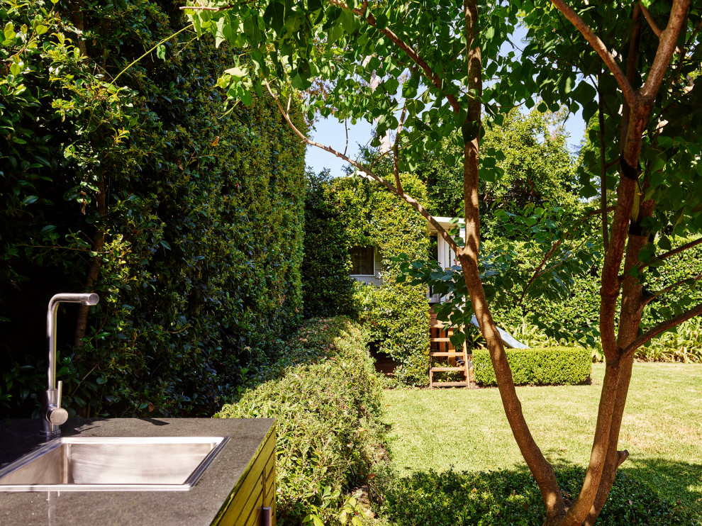 Large contemporary backyard formal garden in Sydney.