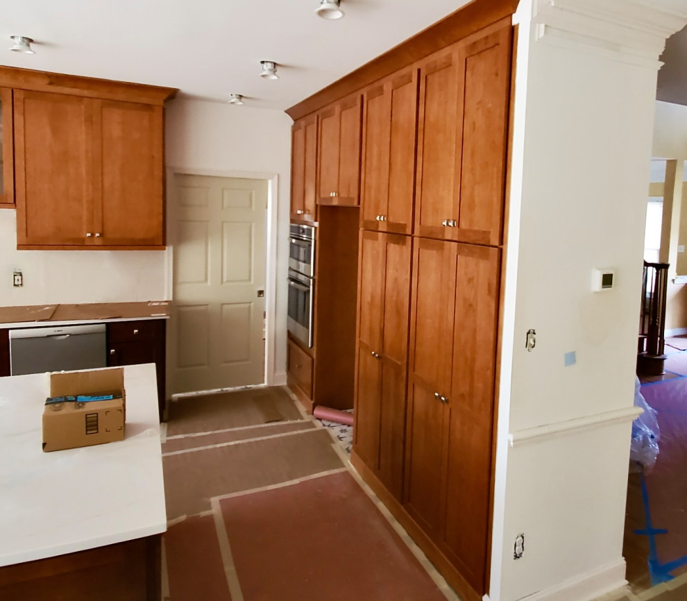 Inspiration for a large transitional ceramic tile and multicolored floor eat-in kitchen remodel in DC Metro with an undermount sink, shaker cabinets, medium tone wood cabinets, quartzite countertops, multicolored backsplash, stone tile backsplash, stainless steel appliances, an island and white countertops