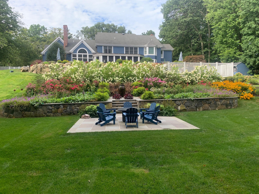 Inspiration for a large classic sloped xeriscape full sun garden for summer in New York with a flowerbed and gravel.