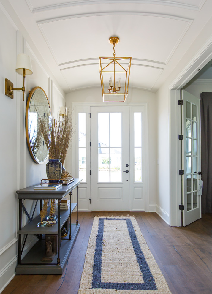 Design ideas for a beach style entry hall in Jacksonville with white walls, medium hardwood floors, a single front door and a white front door.