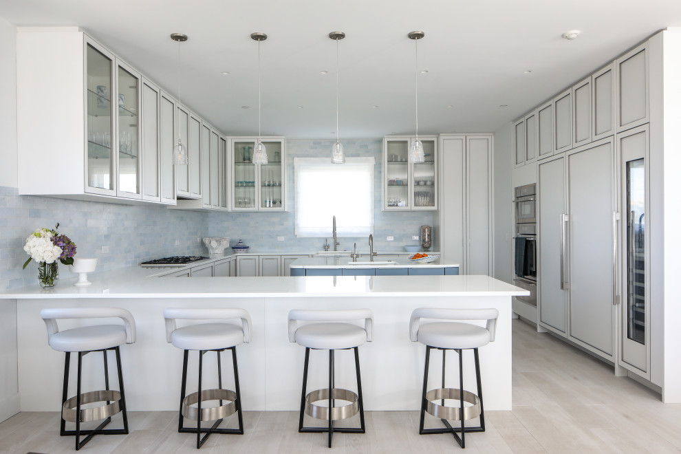 Eat-in kitchen - mid-sized modern u-shaped medium tone wood floor eat-in kitchen idea in New York with an undermount sink, shaker cabinets, white cabinets, quartz countertops, multicolored backsplash, subway tile backsplash, stainless steel appliances, an island and white countertops