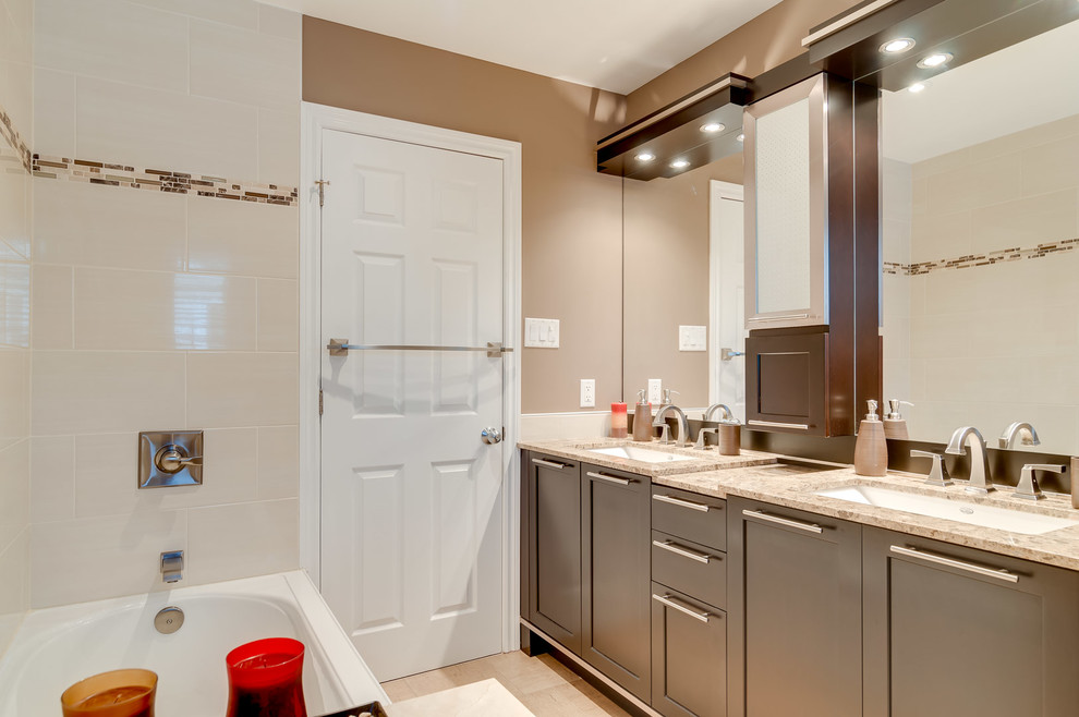 This is an example of a mid-sized transitional master bathroom in Ottawa with an undermount sink, shaker cabinets, dark wood cabinets, granite benchtops, a drop-in tub, a corner shower, a one-piece toilet, multi-coloured tile, ceramic tile, brown walls and ceramic floors.