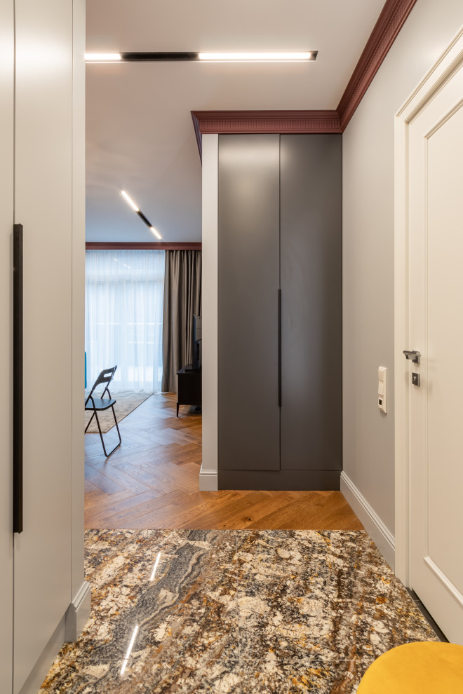 This is an example of a small transitional front door in Saint Petersburg with granite floors, a single front door and multi-coloured floor.